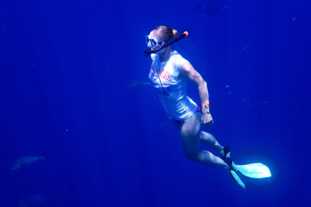 a woman in a snorkeling mask underwater